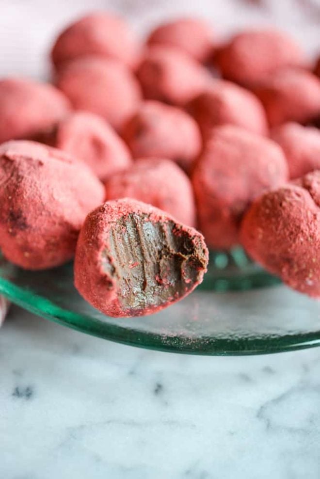 a green glass plate of Dark Chocolate Strawberry Truffles