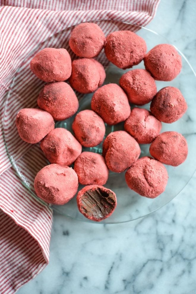 overhead view of a green glass plate of Dark Chocolate Strawberry Truffles