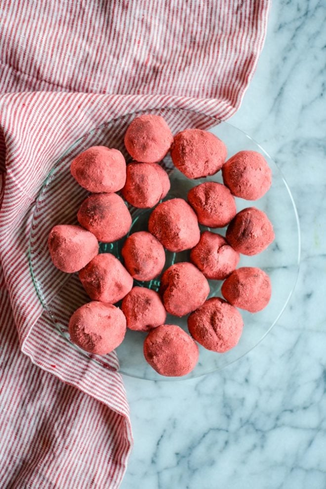 overhead view of a green glass plate of Dark Chocolate Strawberry Truffles