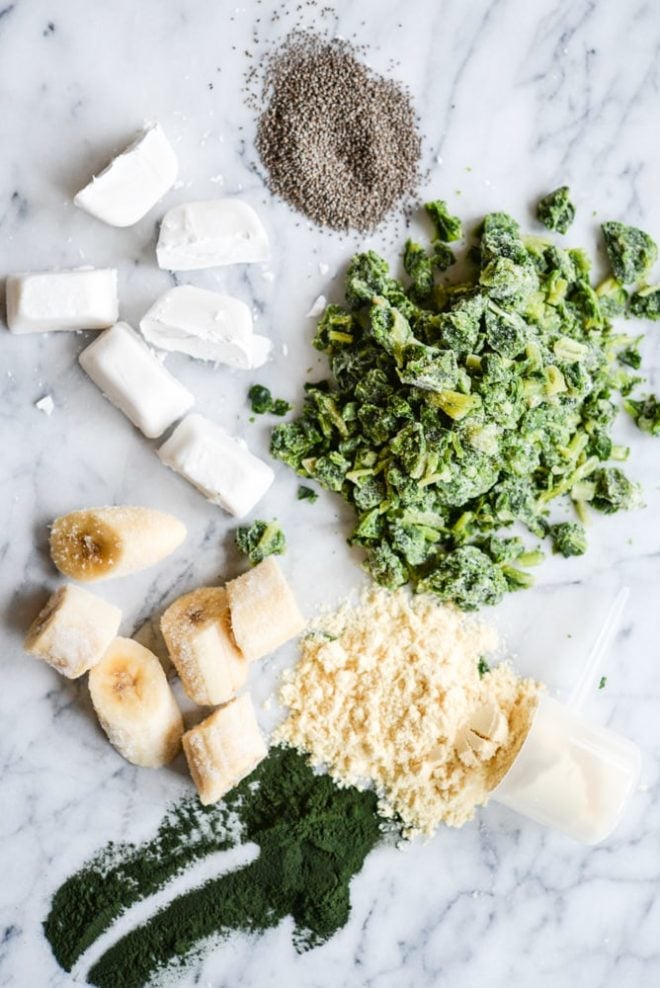 Bananas, spinach, coconut milk ice cubes, and protein powder for Green Protein Smoothie Freezer Packs Fed