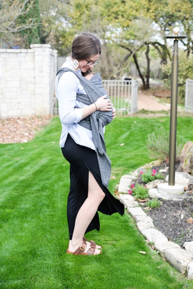 woman wearing a baby in a carrier outside