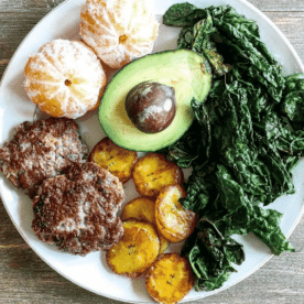 DIY Egg Free Breakfast plate with sausage, oranges, avocado, kale and plantains