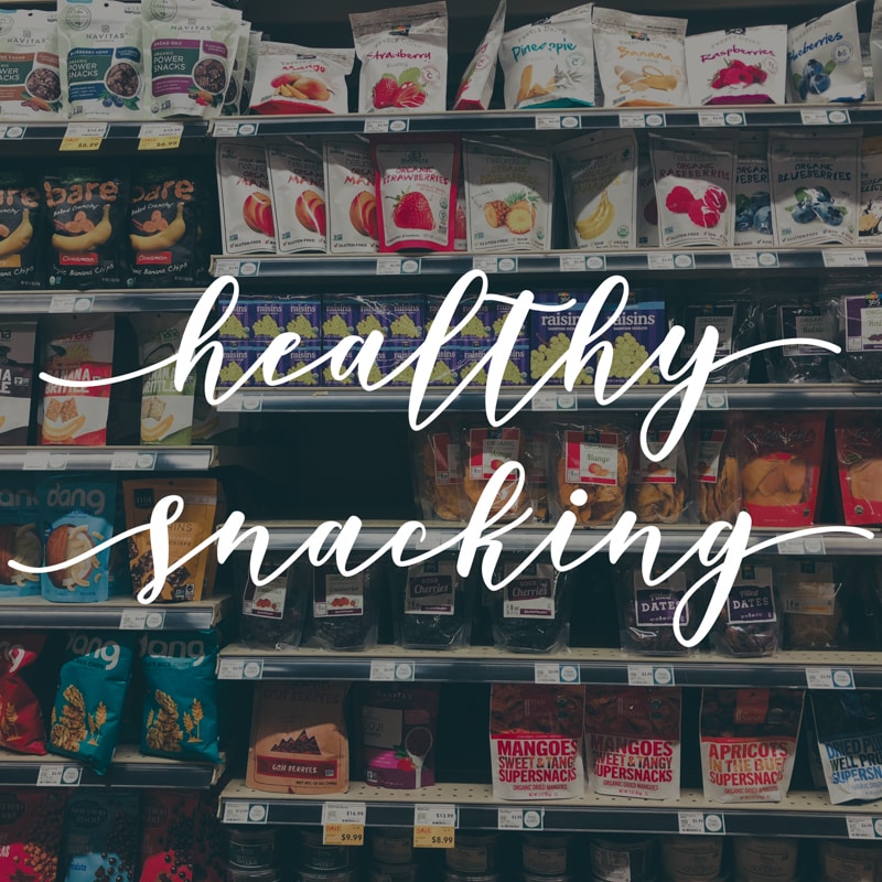 the healthy snack aisle in Whole Foods with text overlay "healthy snacking"