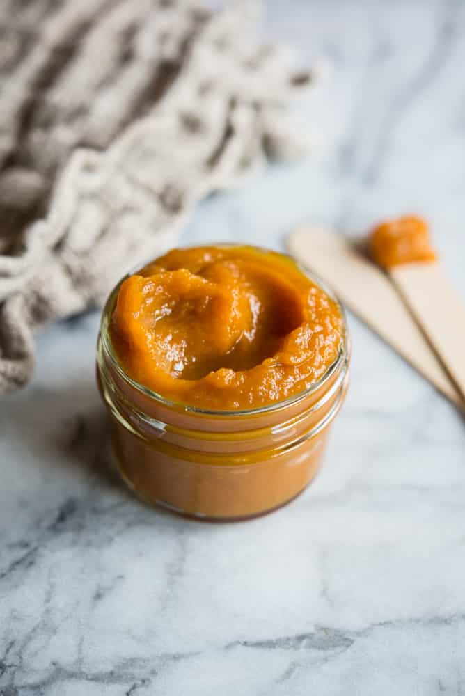 a jar of DIY Pumpkin facial mask on a marble table