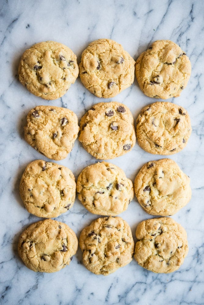 overhead view of chewy gluten free chocolate chip cookies on a marble table