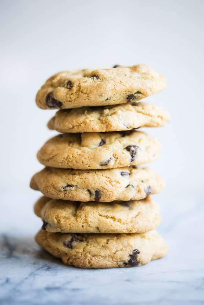 stack of chewy gluten free chocolate chip cookies on a marble table