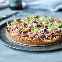 a whole Chicago deep dish pizza on a round sheet pan