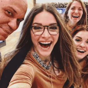 a "selfie" with three long haired smiling women and a bald man