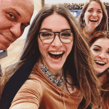 a "selfie" with three long haired smiling women and a bald man