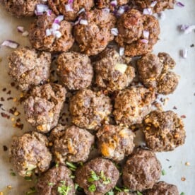 3 flavors of baked meatballs on a sheet pan