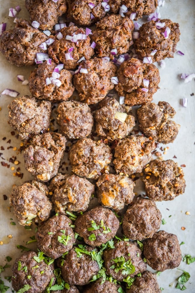3 flavors of baked meatballs on a sheet pan