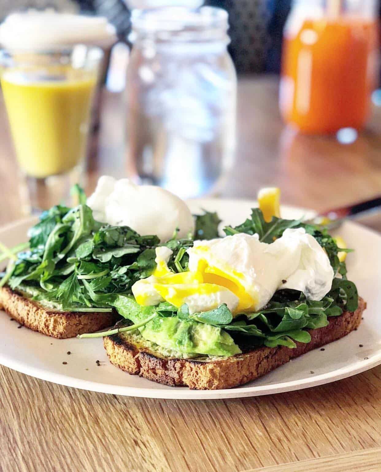 a plate of gluten free avocado toast with poached eggs on top at wellness retreat in phoenix