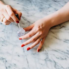 woman painting her nails with non-toxic nail polish
