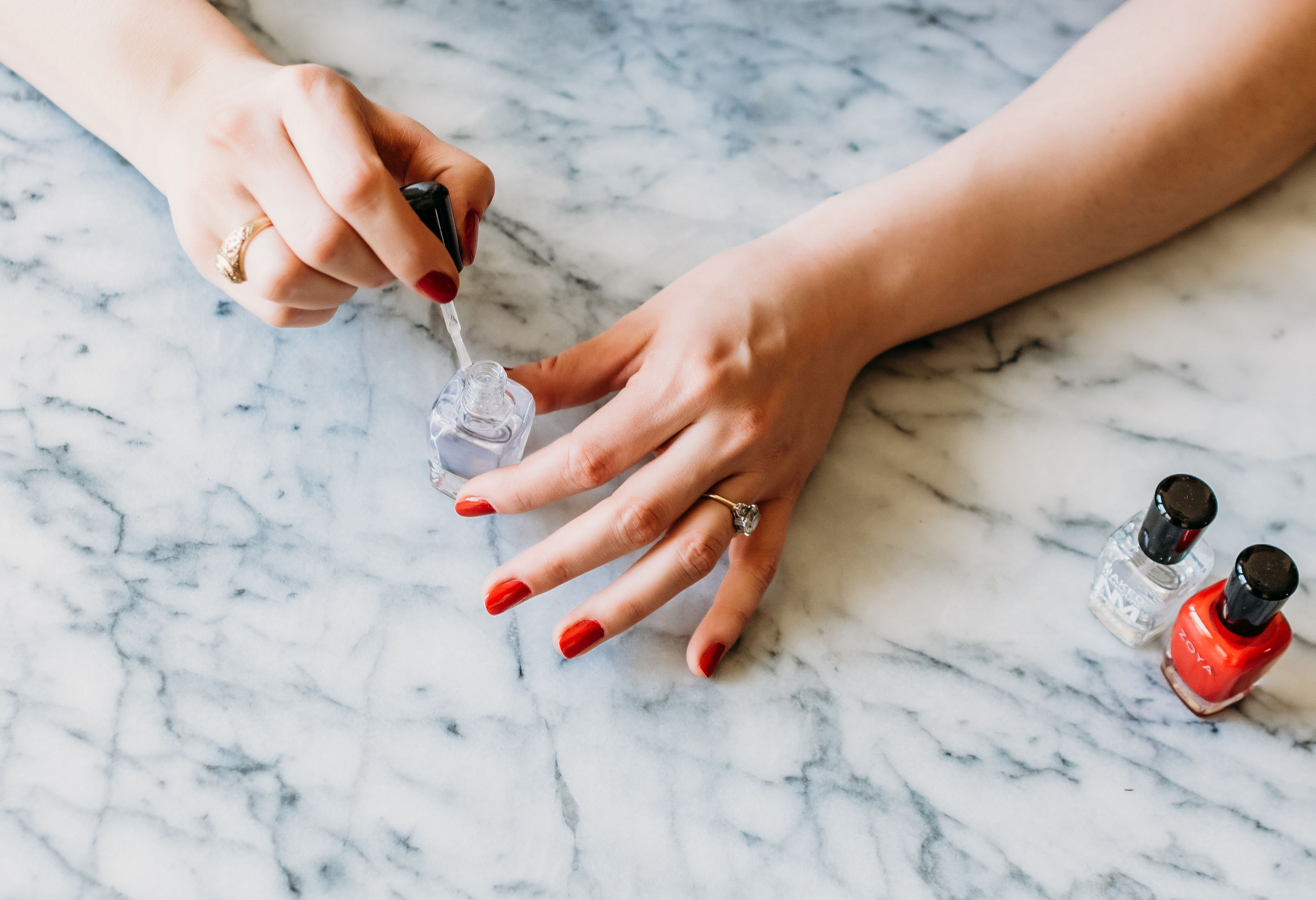 woman painting her nails with non-toxic nail polish
