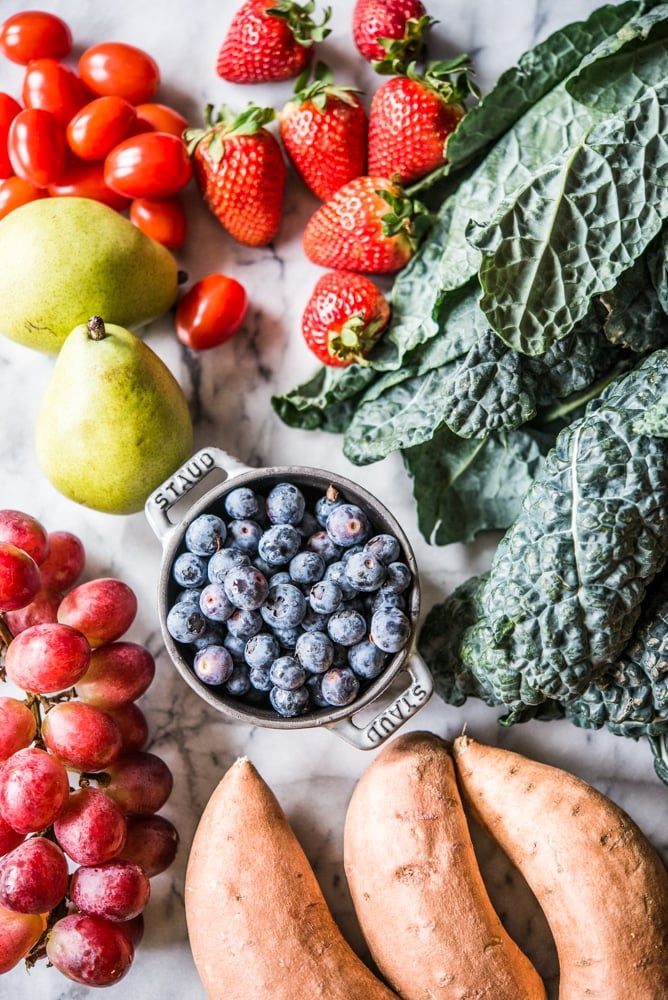 nutrient dense vegetables and fruit on a marble surface