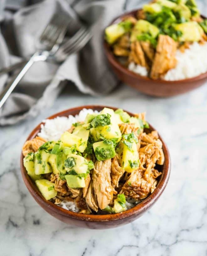 wooden bowls filled with white rice topped with Hawaiian chicken and pineapple avocado salsa on a marble board - healthy instant pot chicken recipe