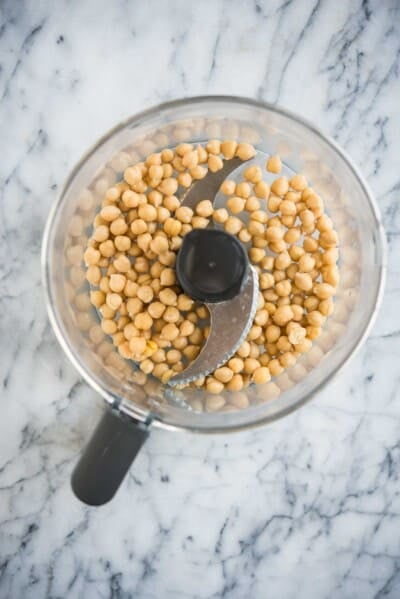 how to make hummus - chickpeas in a food processor