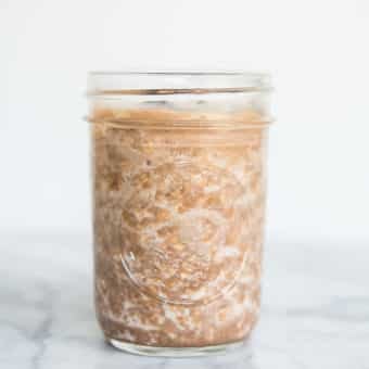chocolate peanut butter overnight oats in a mason jar sitting on a marble counter