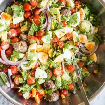 Breakfast salad in a metal bowl on a marble board