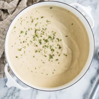 instant pot cauliflower leek soup in a white pot on a marble board