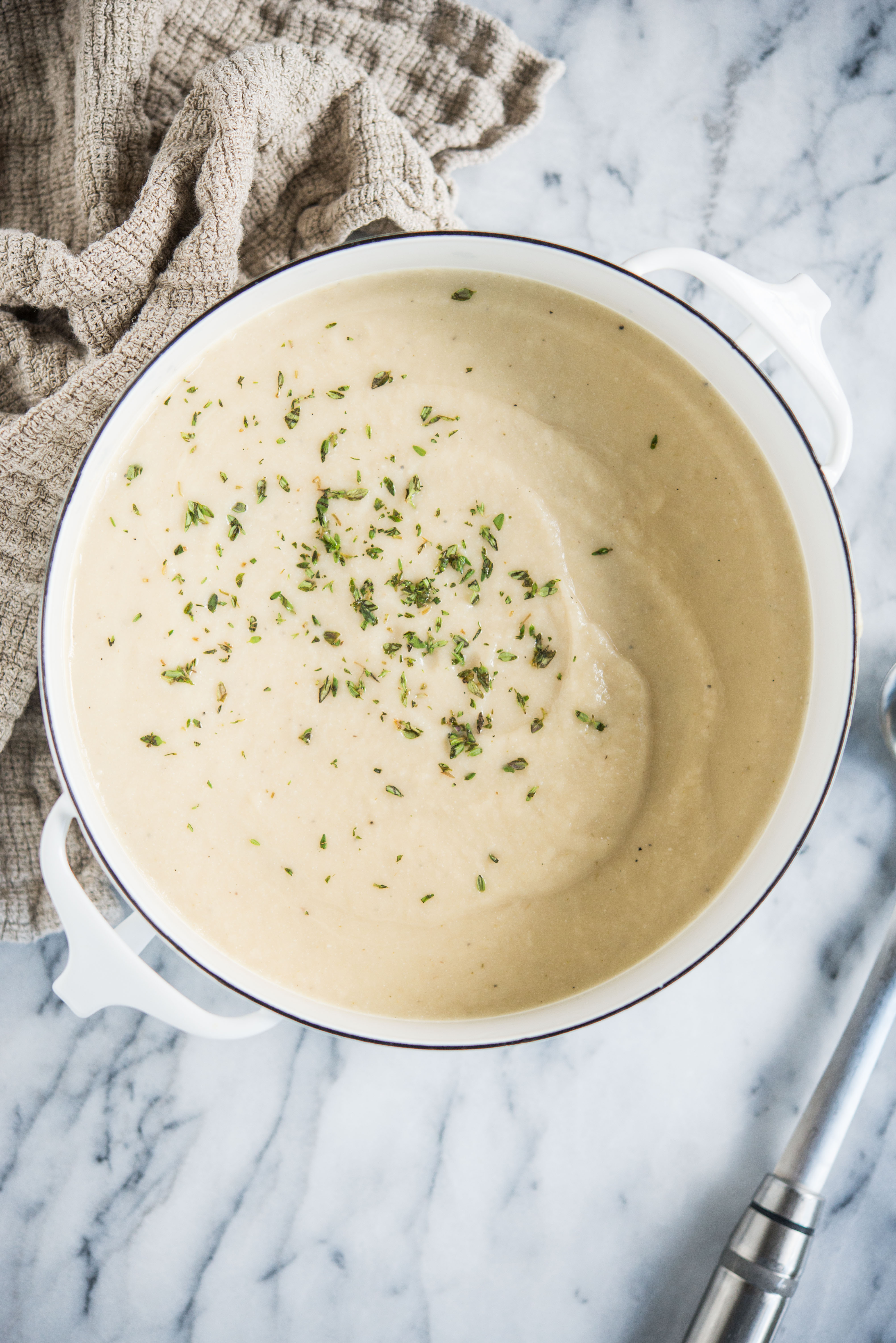 instant pot cauliflower leek soup in a white pot on a marble board