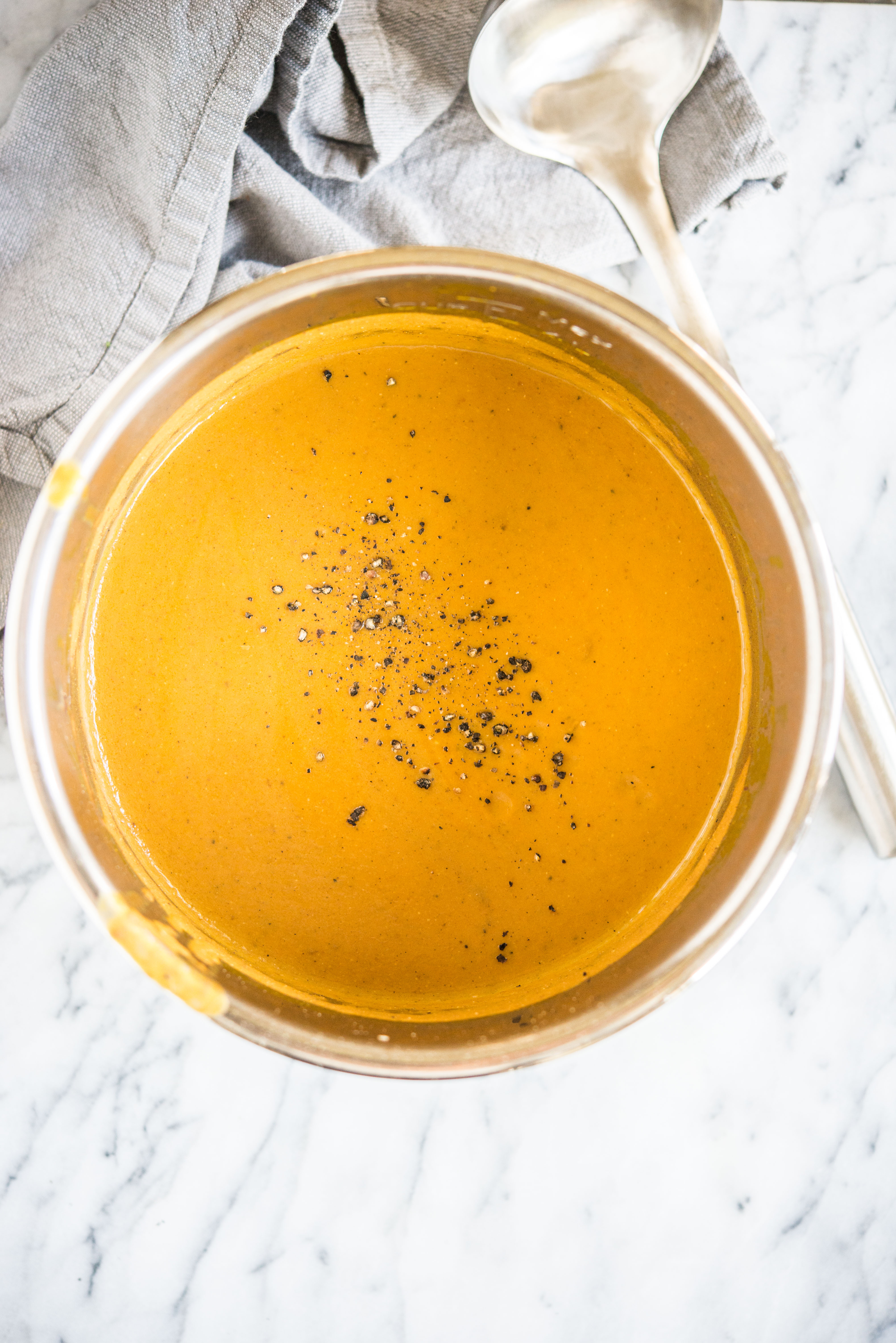 Instant Pot creamy pumpkin soup in an instant pot on a marble board