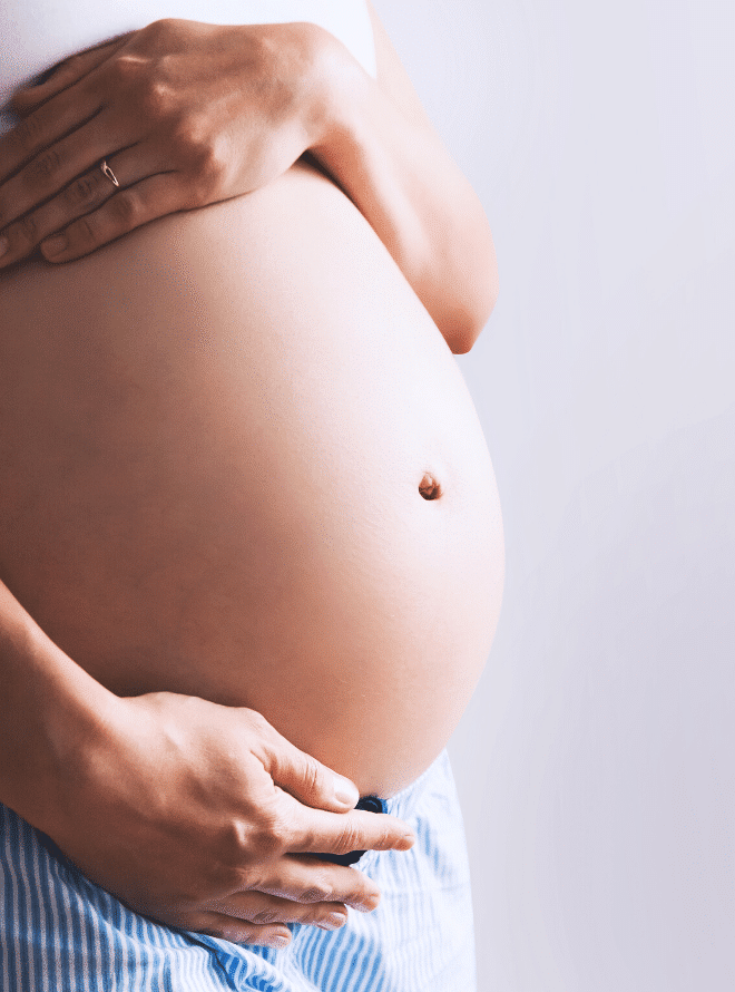 preparing your body for pregnancy - pregnant woman holding her belly