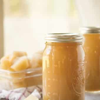 bone broth in a mason jar with bone broth cubes behind it