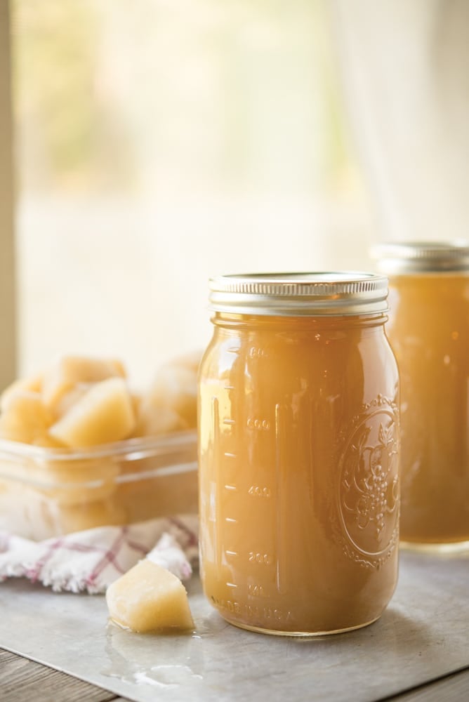 bone broth in a mason jar with bone broth cubes behind it