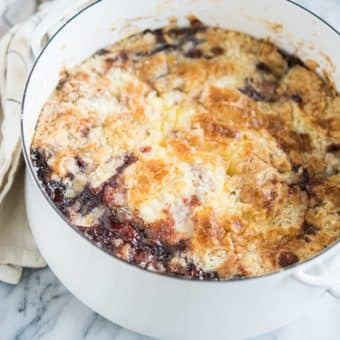 cherry dump cake in a round white casserole dish