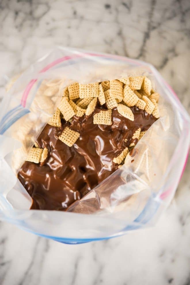 melted chocolate and peanut butter poured over chex in a ziplock bag