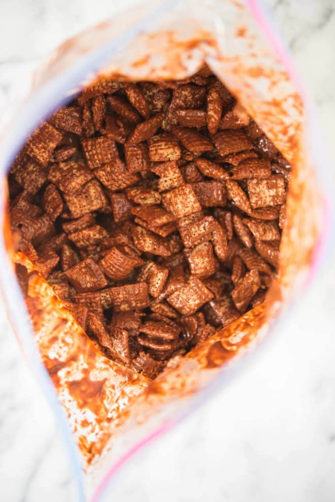 chex mix with chocolate and peanut butter shaken up in a ziplock bag - how to make puppy chow