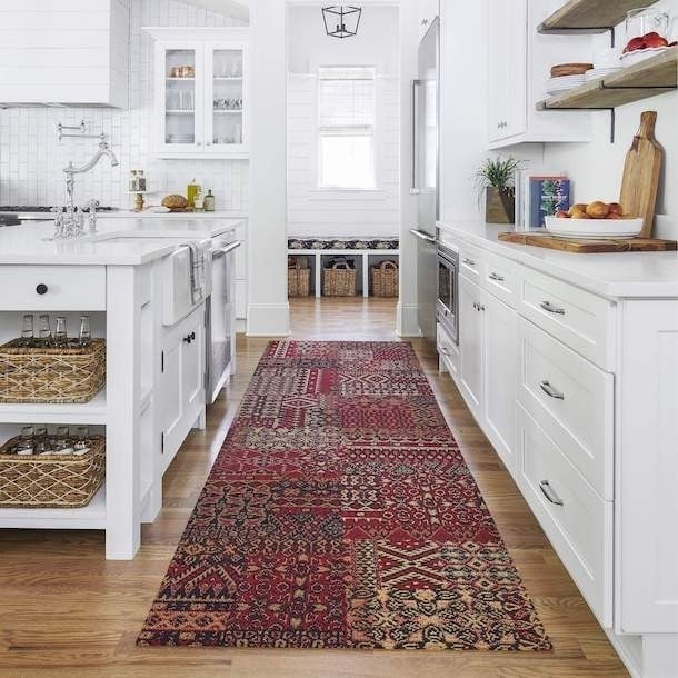 maroon patterned non-toxic rug on a wood floor in a white kitchen