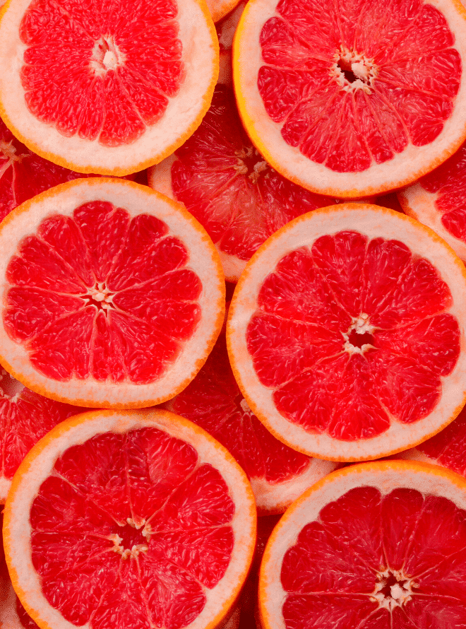 red grapefruit slices laid on top of one another - grapefruit is one way to prepare your body for pregnancy