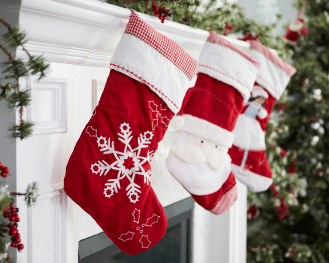 3 stockings hung on a white fireplace