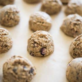 no-bake blueberry energy balls on parchment paper