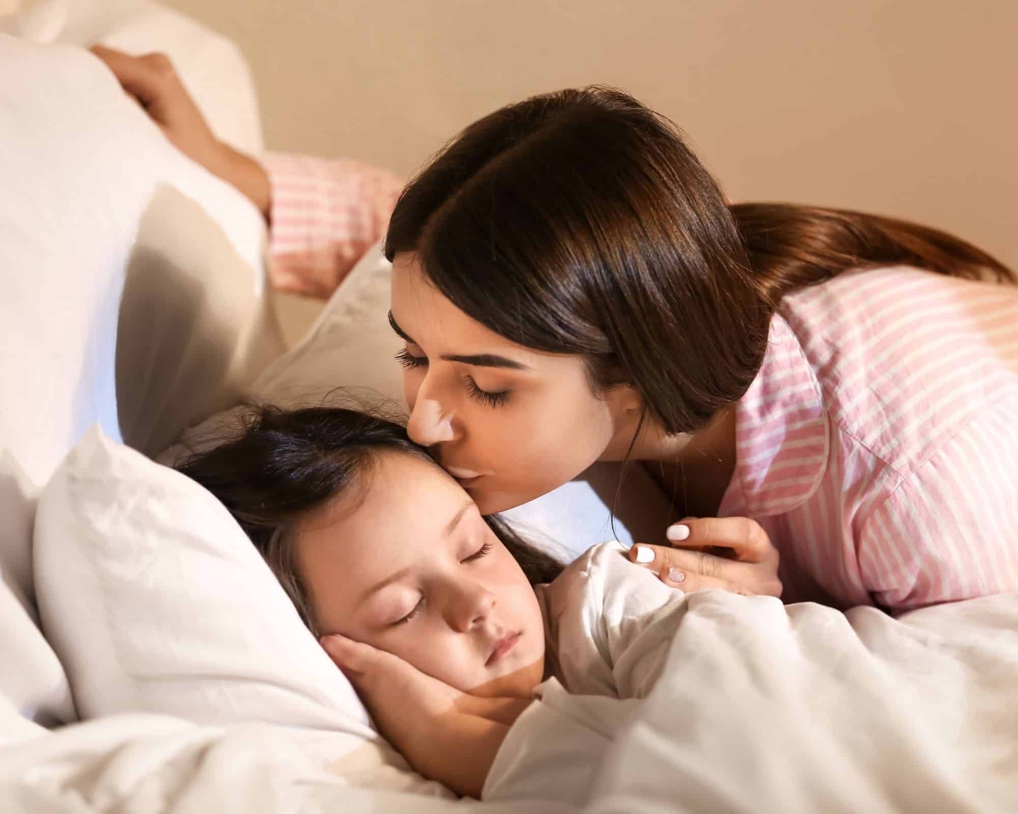 baby sleep - woman putting her child to bed