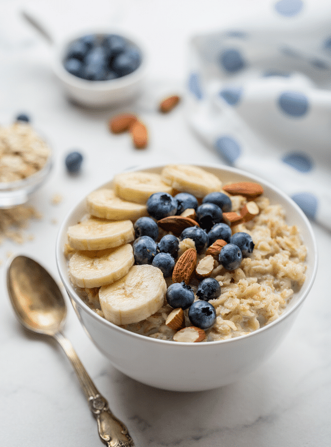bowl of oatmeal with blueberries, bananas, and almonds - what to eat in your first trimester