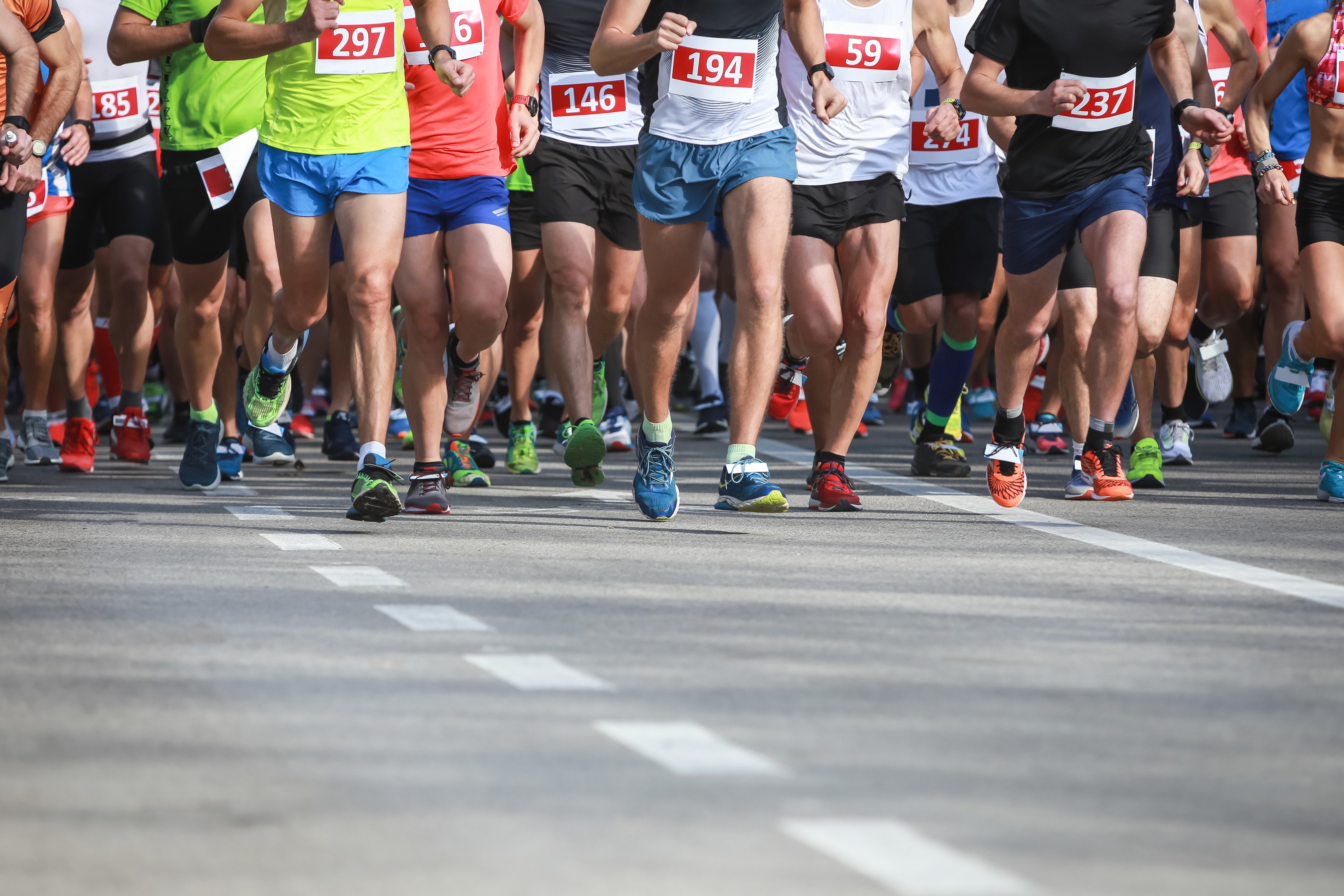 A front view of people running at the half marathon event.