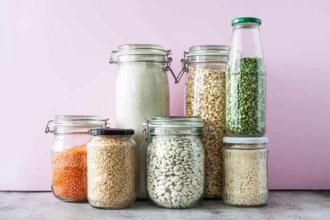 Variety of grains and legumes in glass jars