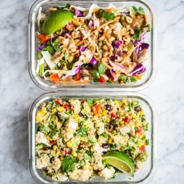 thai chicken salad and southwestern quinoa salad in clear individual portion containers on a marble surface