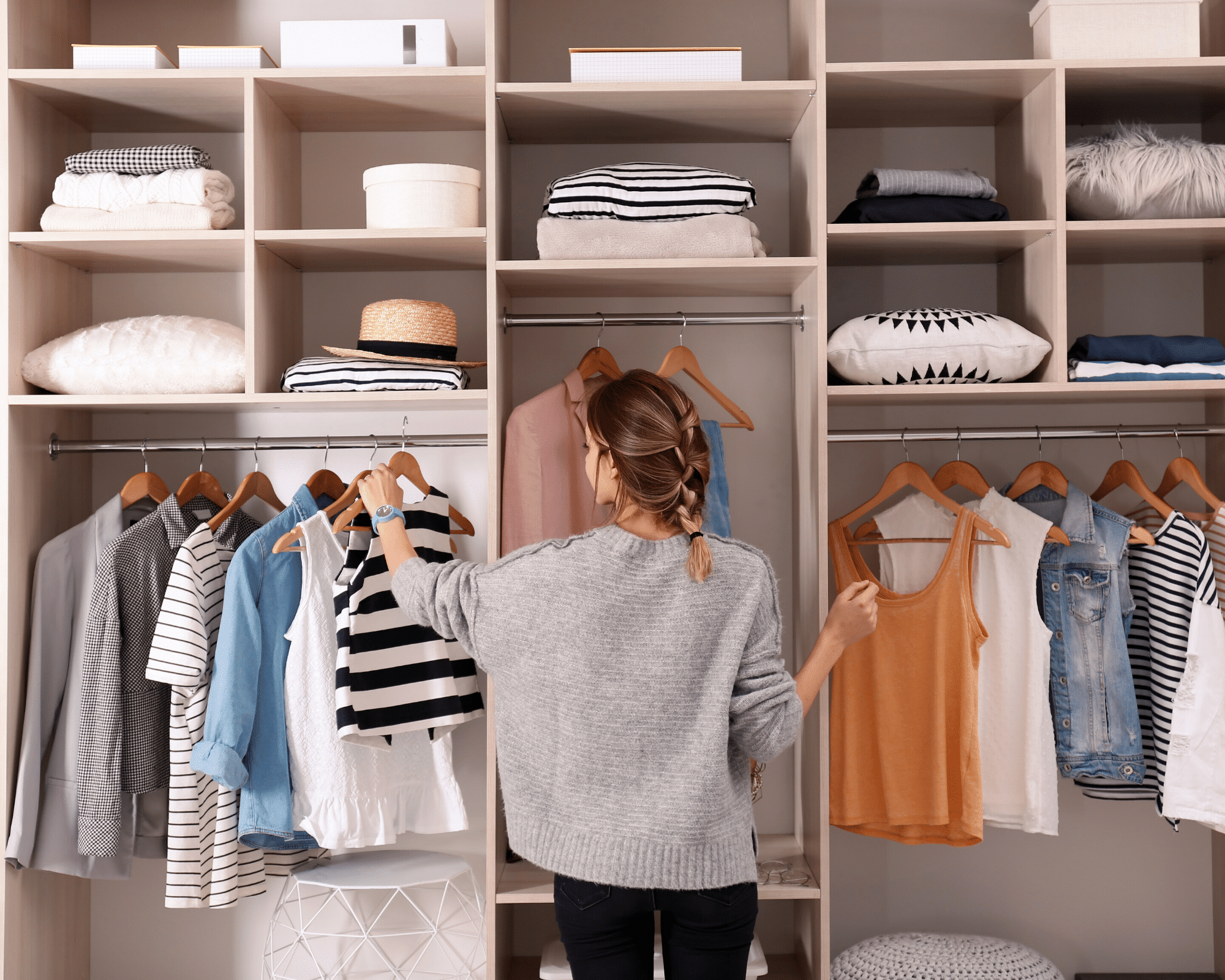 woman in her closet deciding what to wear