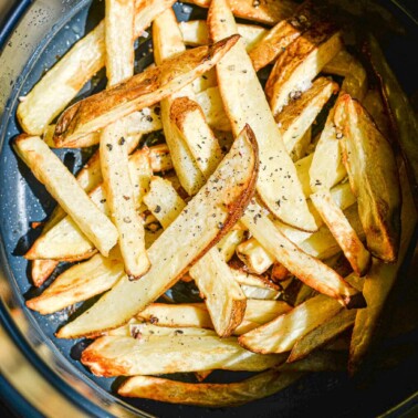 crispy french fries in an air fryer basket