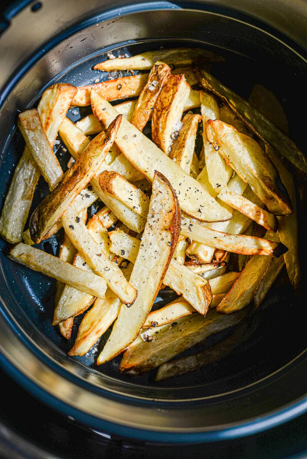 crispy french fries in an air fryer basket