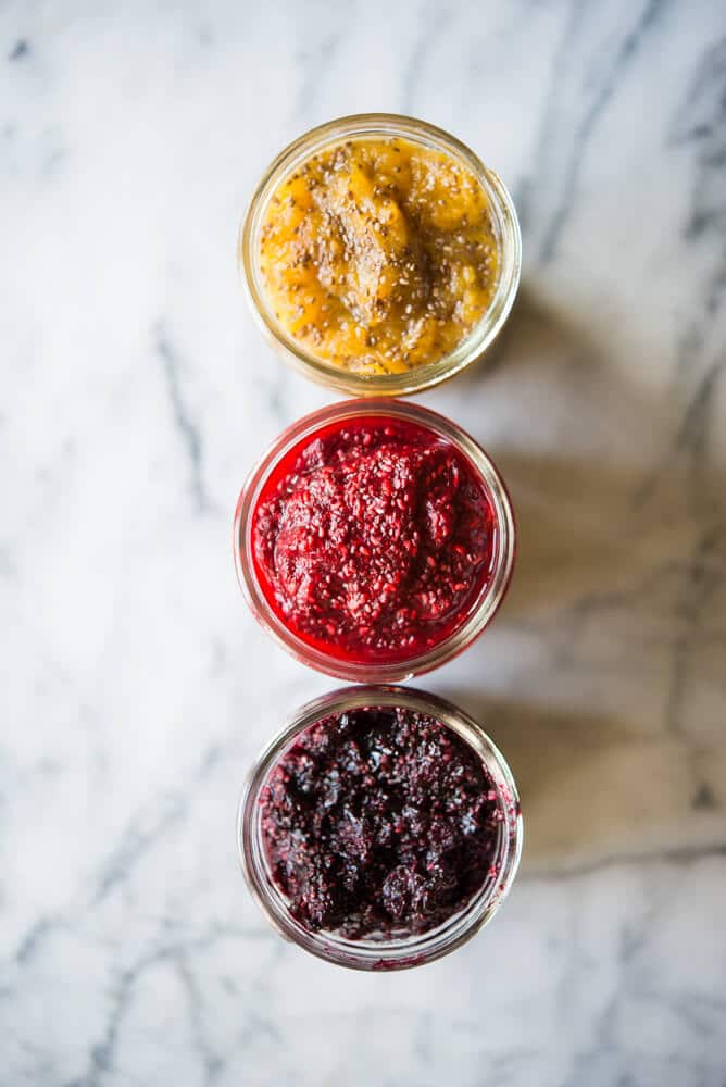 top view of 3 mason jars of different colored chia jam