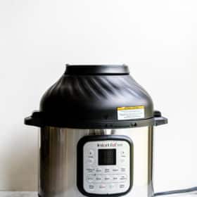 instant pot duo crisp with air fryer lid on a marble surface