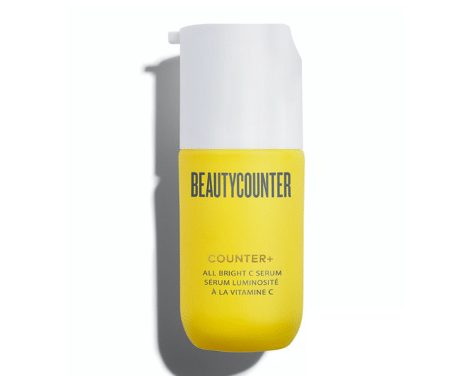 beautycounter all bright serum in a bright yellow and white bottle