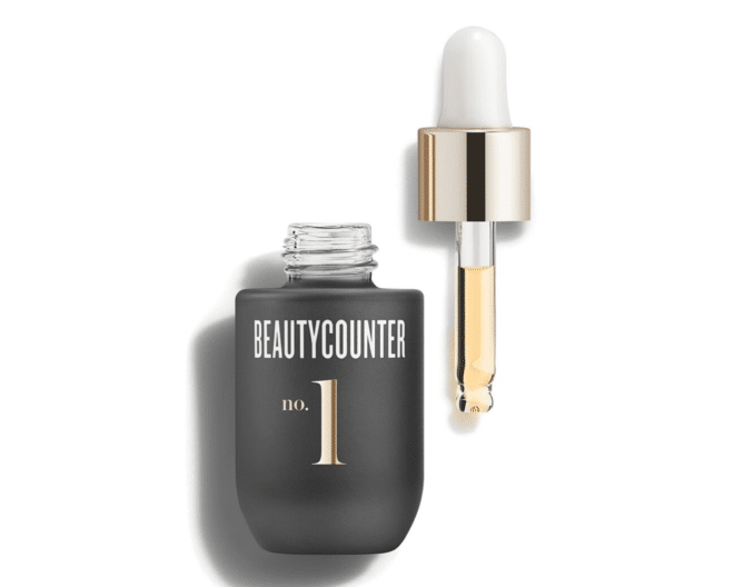 beautycounter no.1 brightening oil in a dark gray and gold bottle
