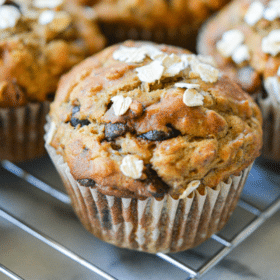 freshly baked chocolate chip banana oat muffins cooling on a cooling rack