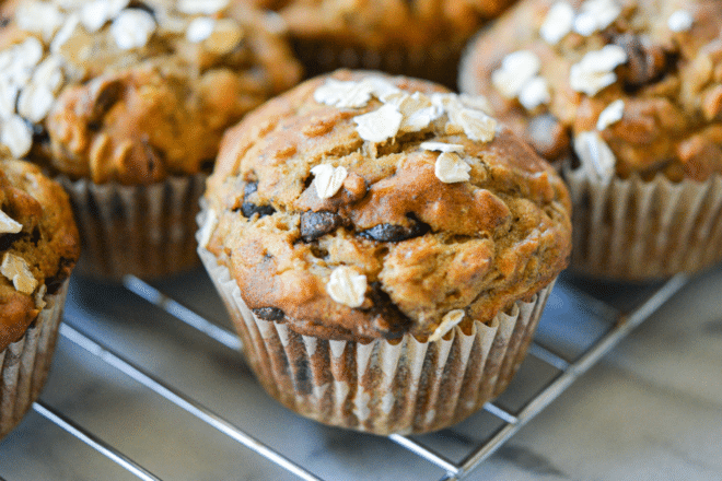 freshly baked chocolate chip banana oat muffins cooling on a cooling rack